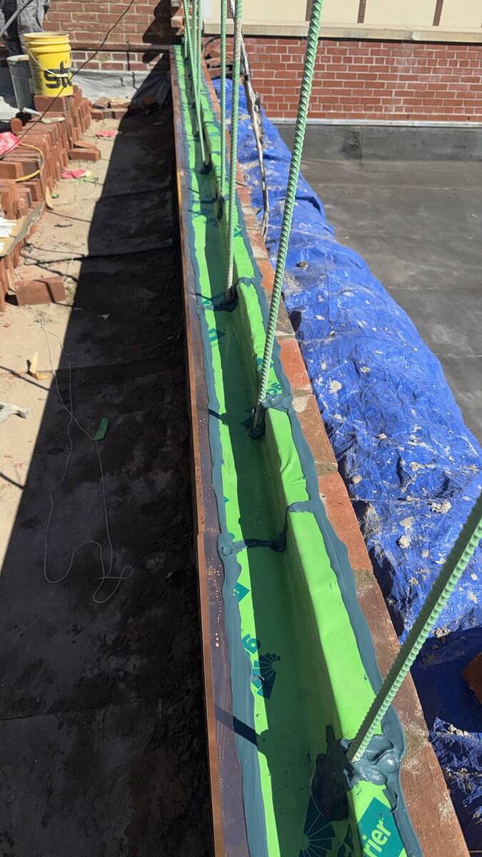 Roofing crew applying a waterproof membrane