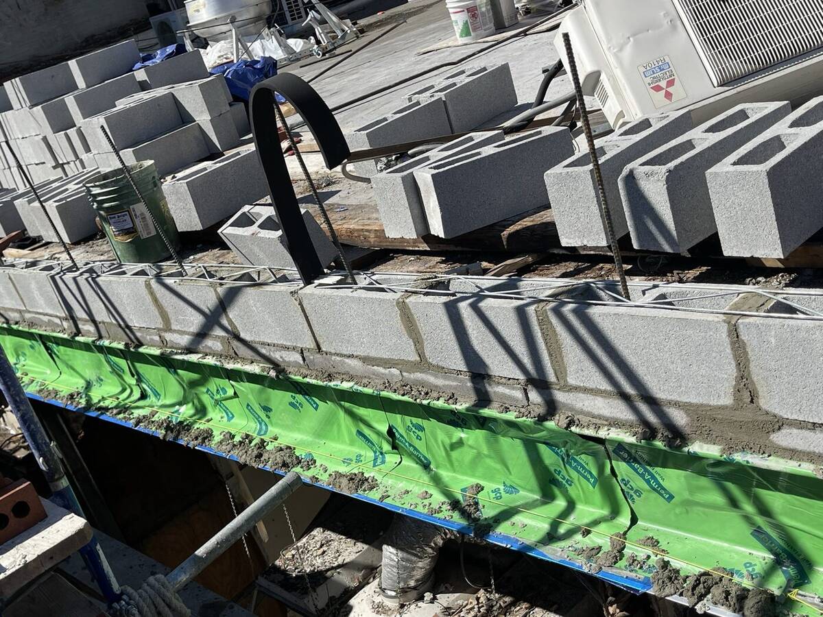 Roofing crew applying a waterproof membrane