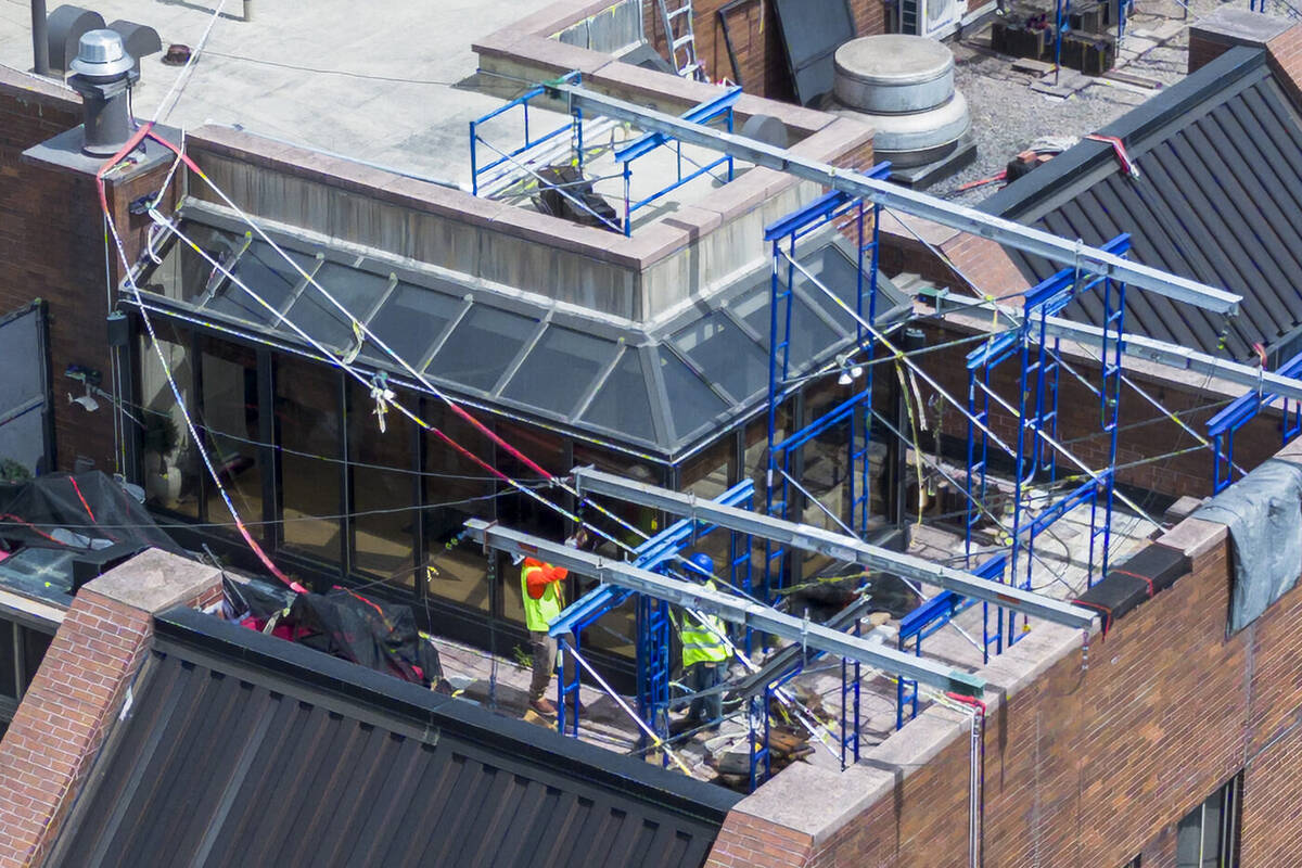 Sidewalk shed and scaffolding installation along a building facade